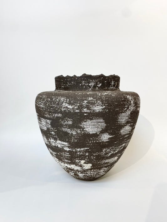 Black textured vase on a white background