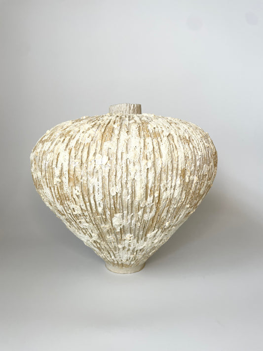 Textured ceramic vase on a plain background