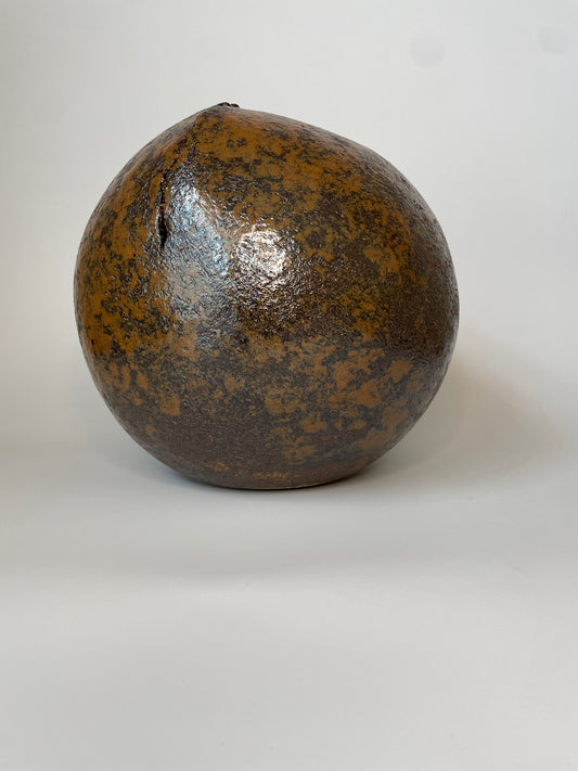 Bronze-colored spherical object on a white background